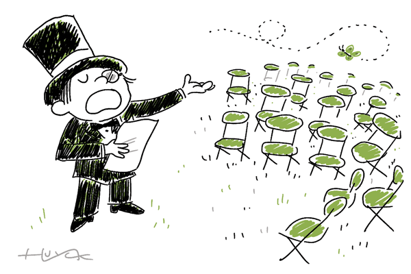 A boy in a tux reads poetry to a bunch of empty chairs.