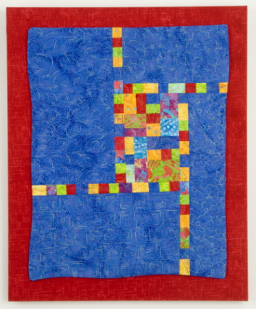 Blue wall quilt with primary blocks