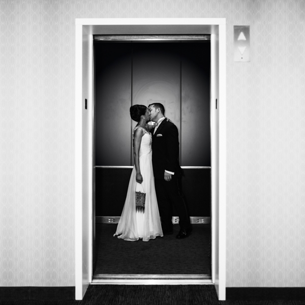 Romantic wedding photos: Bride & groom kissing in an elevator 