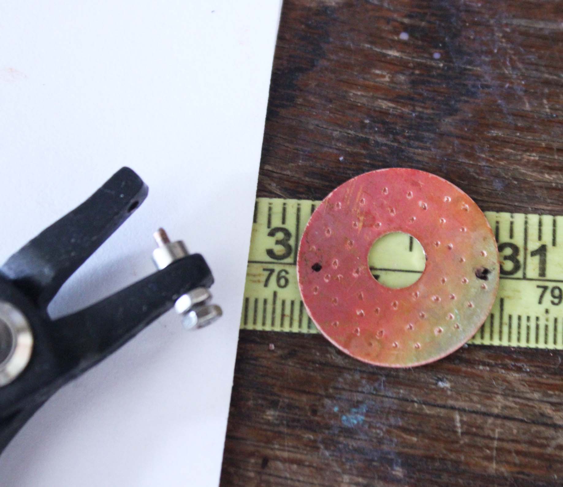 Use a permanent market and a straight edge to marke holes to be punched on washer