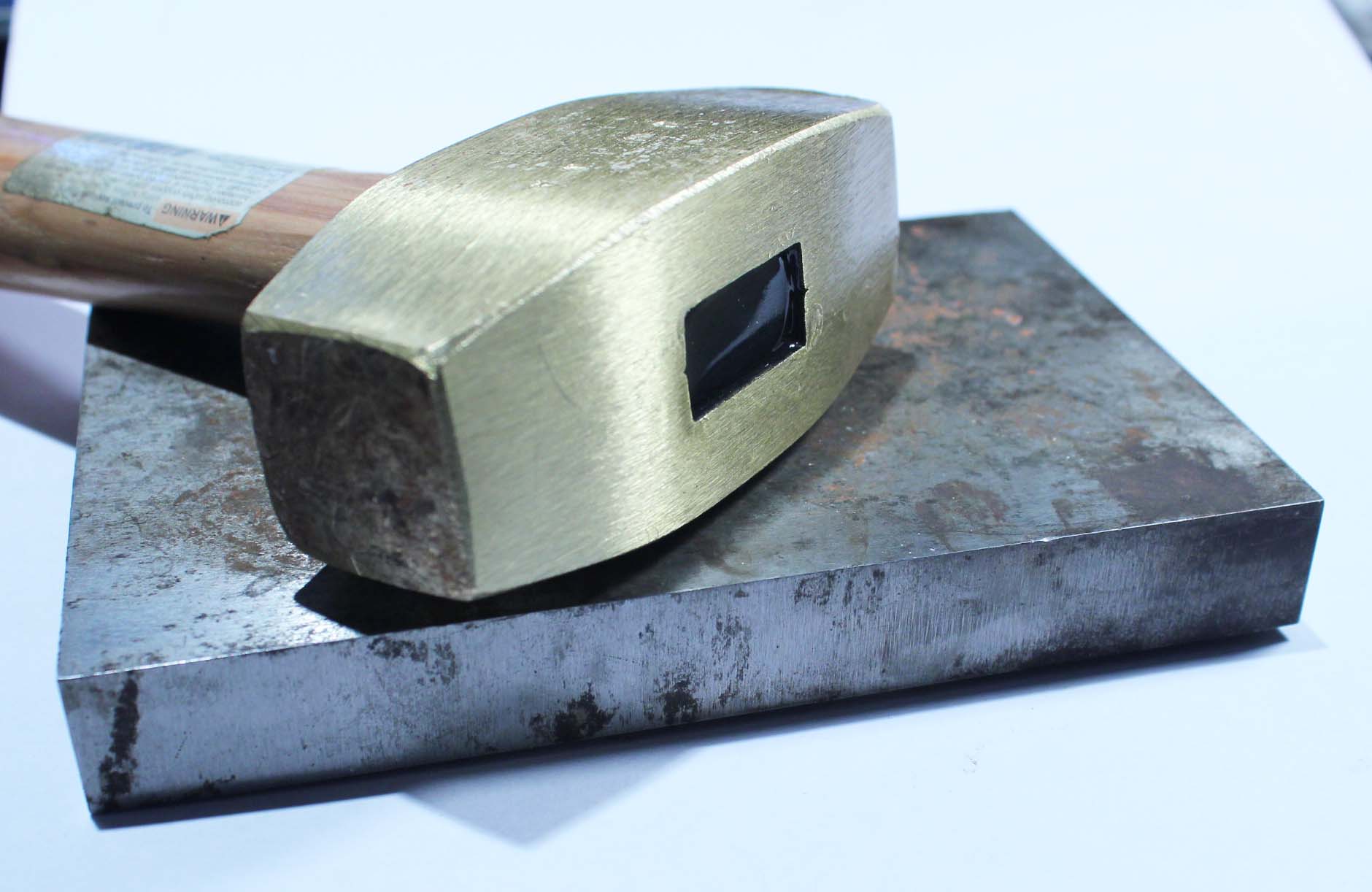 Brass hammer and steel bench block