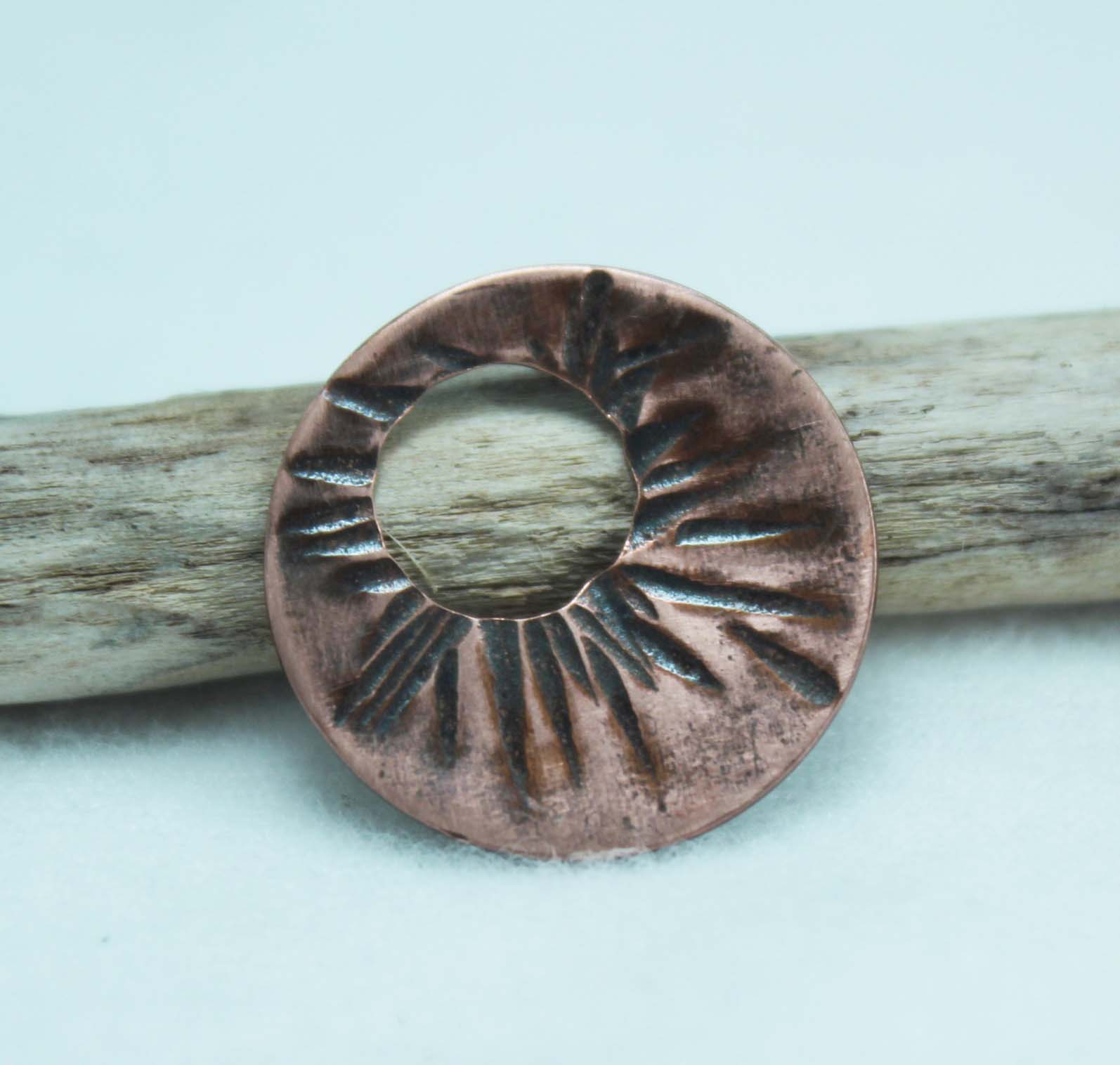 Copper disc textured using the chisel end of a riveting hammer