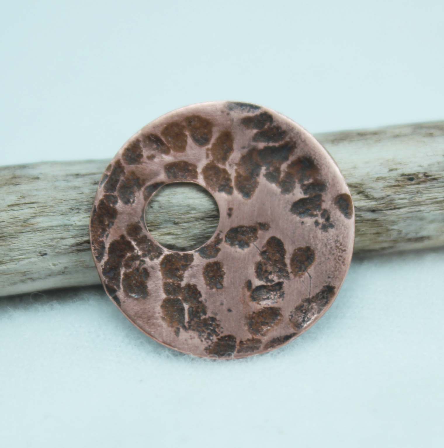 copper disc textured using a large ball peen hammer