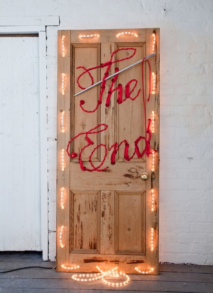 Wooden door with the words 'The End' embroidered into it