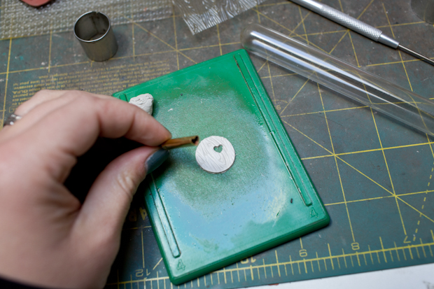 Punching a heart into clay