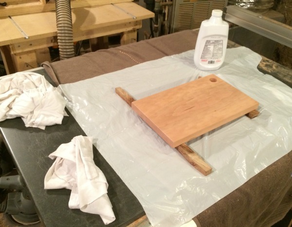 Applying mineral oil to finish handmade cutting board