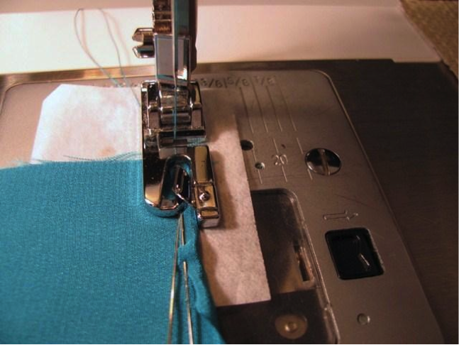 Place tissue paper under the presser foot