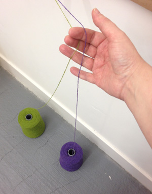 two cones of yarn for warping