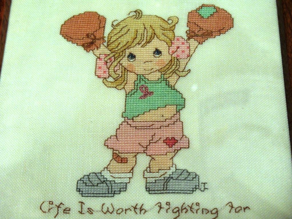 cross stitch pattern of girl in boxing gloves wearing pink ribbon