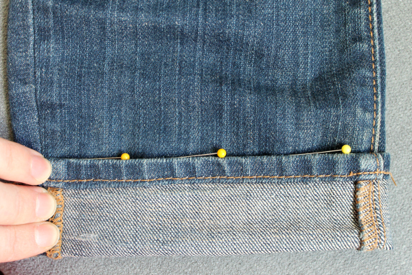 fold new hem of jeans to meet second line of pins