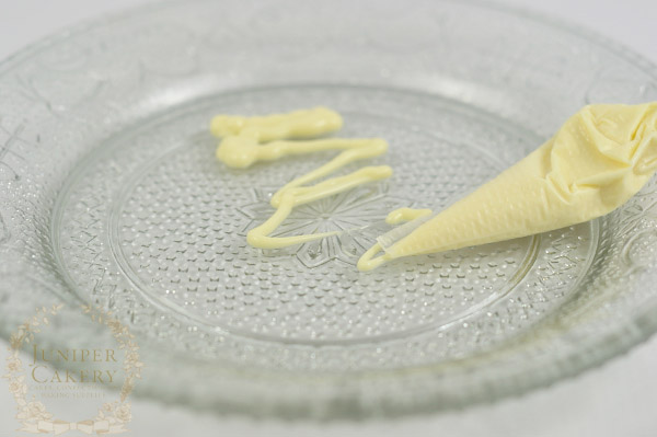 Melt white chocolate 'glue' in a piping bag for less mess and more control