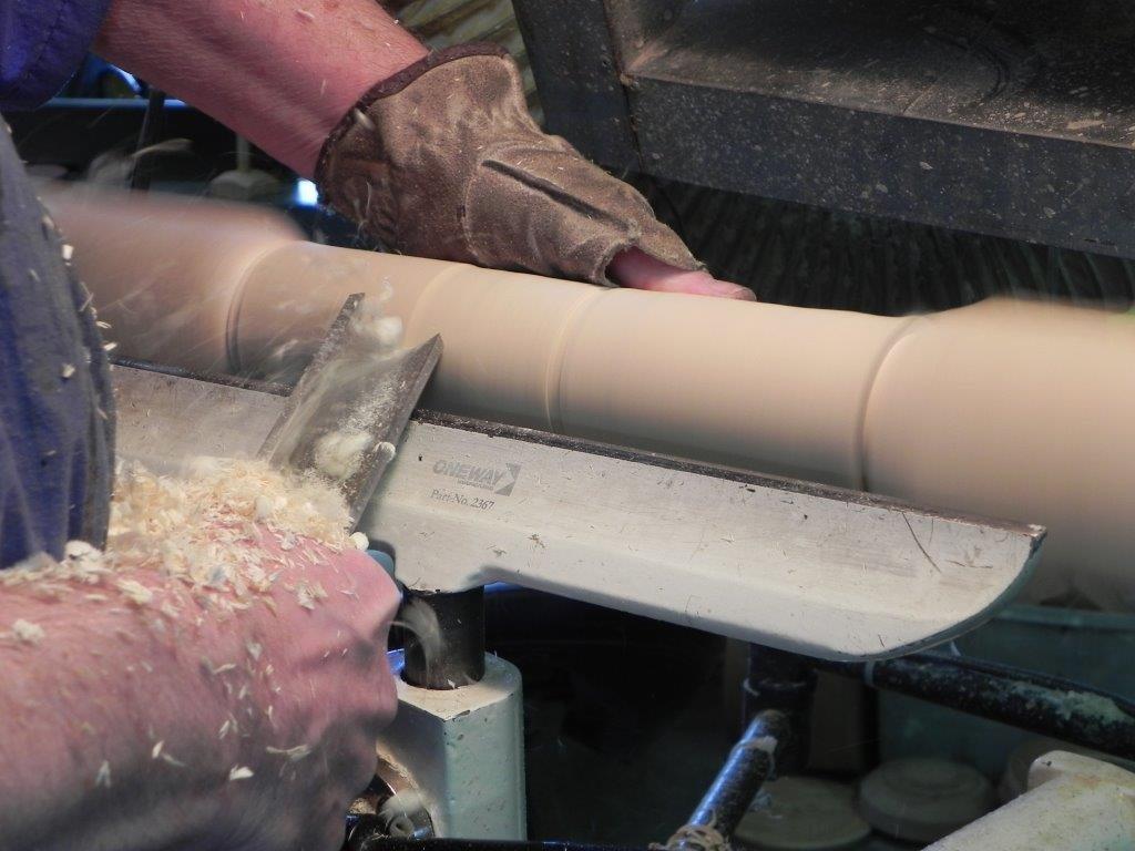 Rough turning the spindle - Using the left hand for a traveling steady rest.