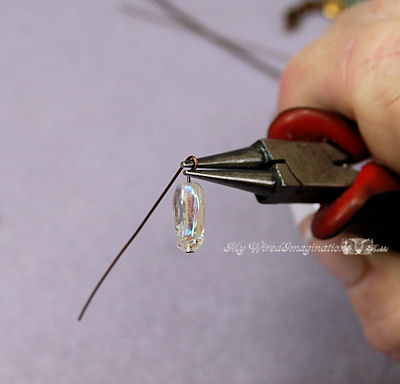 Push the wire back and around the top jaw of the pliers