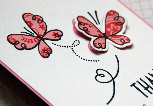 Raised butterfly with pink base showing beneath