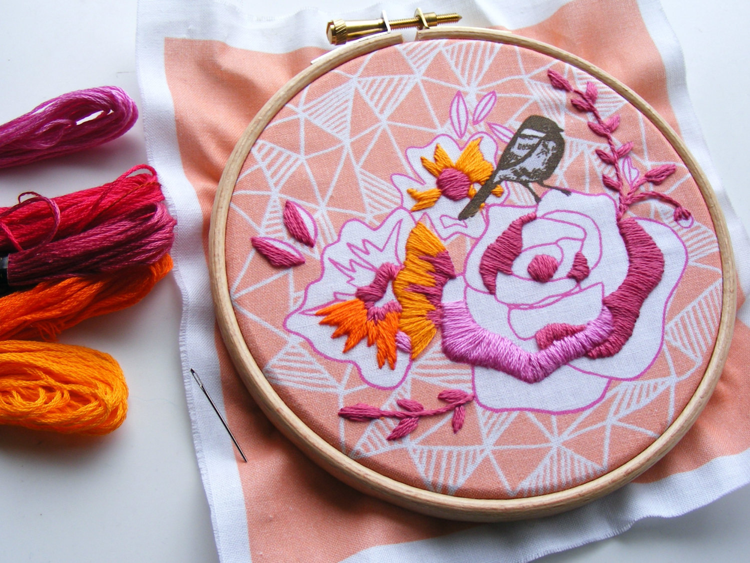 hand embroidered pink and orange rose on geometric fabric