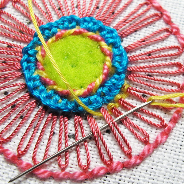 Working a ribbed spider web stitch with a tapestry needle
