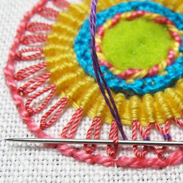Tacking petals on long daisy stitches open