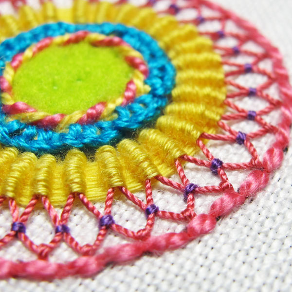 Couching stitch pulls half of two daisy stitches toward each other