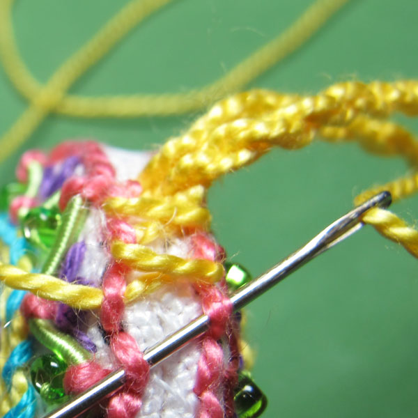 Whip stitching the mouth of a scissor fob closed