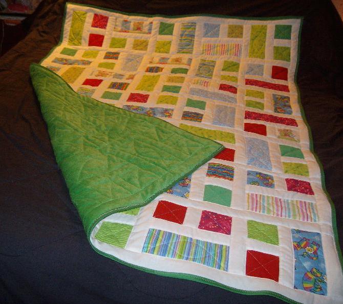 Geometric quilt with green fleece back