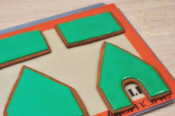 Flood icing a gingerbread house with royal icing by Juniper Cakery