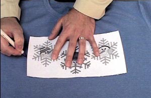 Marking embroidery crosshair location on a shirt.