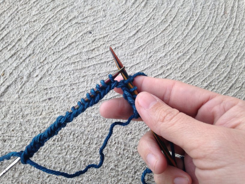 beginning to knit blue yarn in the round