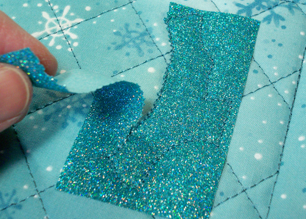 Tear away glitter flex vinyl used with applique.