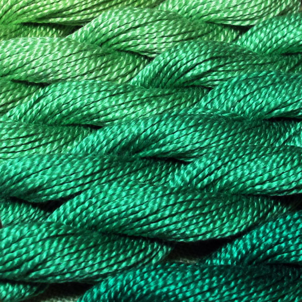 Close-up shot of green perle cotton thread