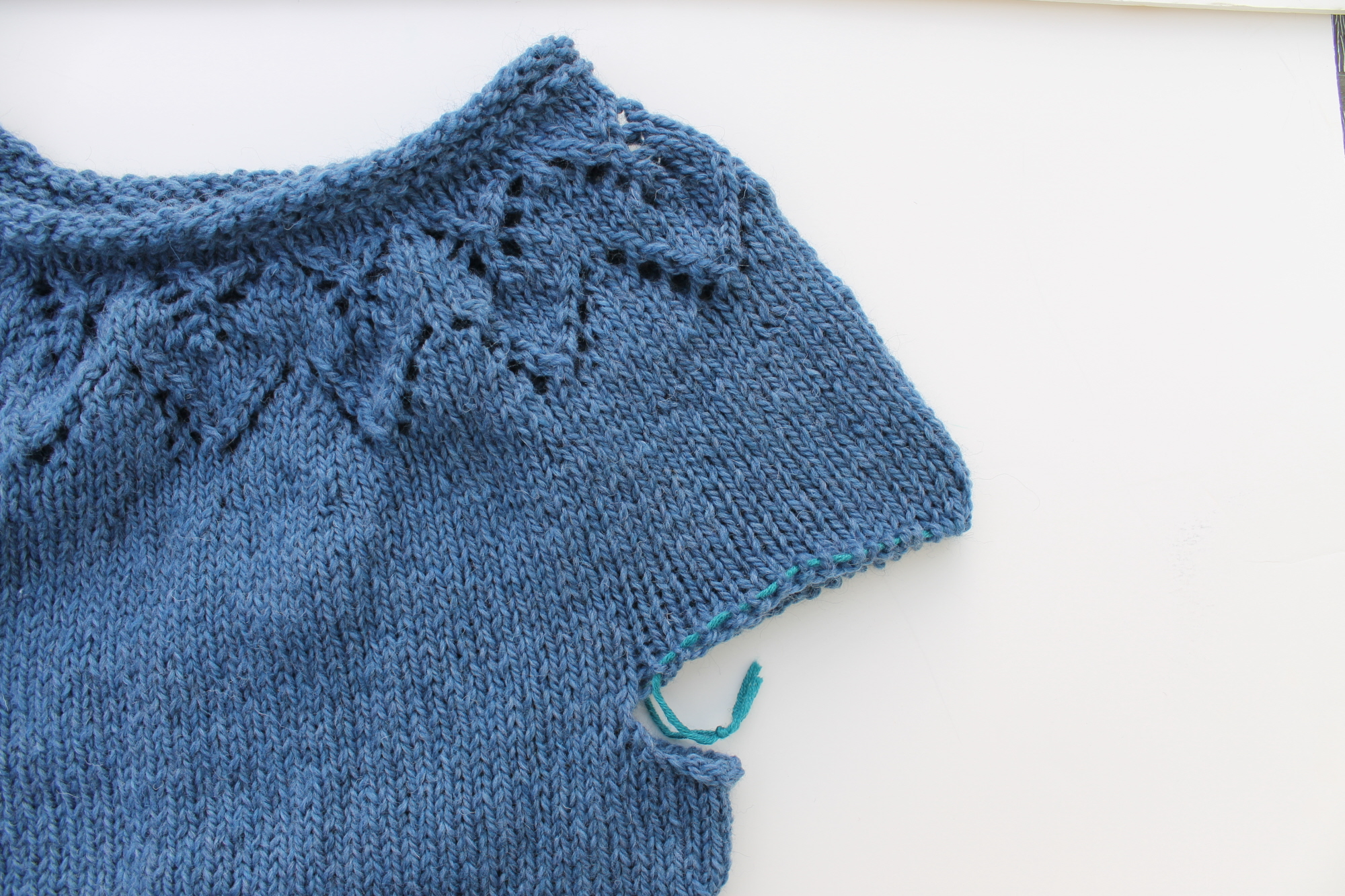 Stitches being held on waste yarn