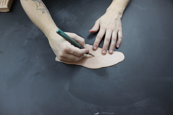 drawing with an exacto knife on clay