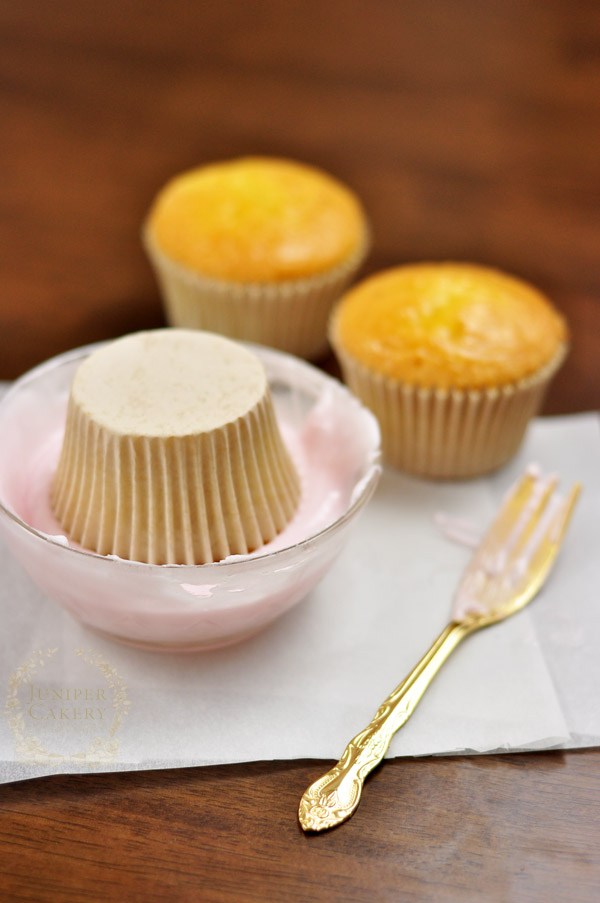 Dipping cupcakes into liquid fondant