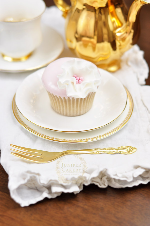 Dipped fondant cupcake with a pretty sugar flower