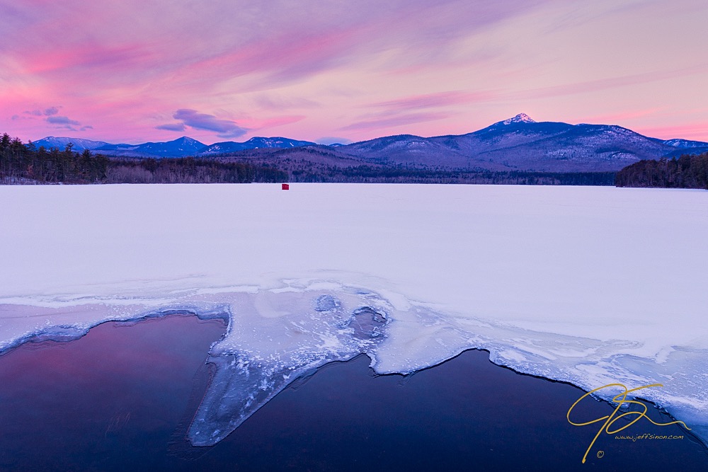 Beautiful winter sunrise over snow and ice covered Chocorua Lake, NH