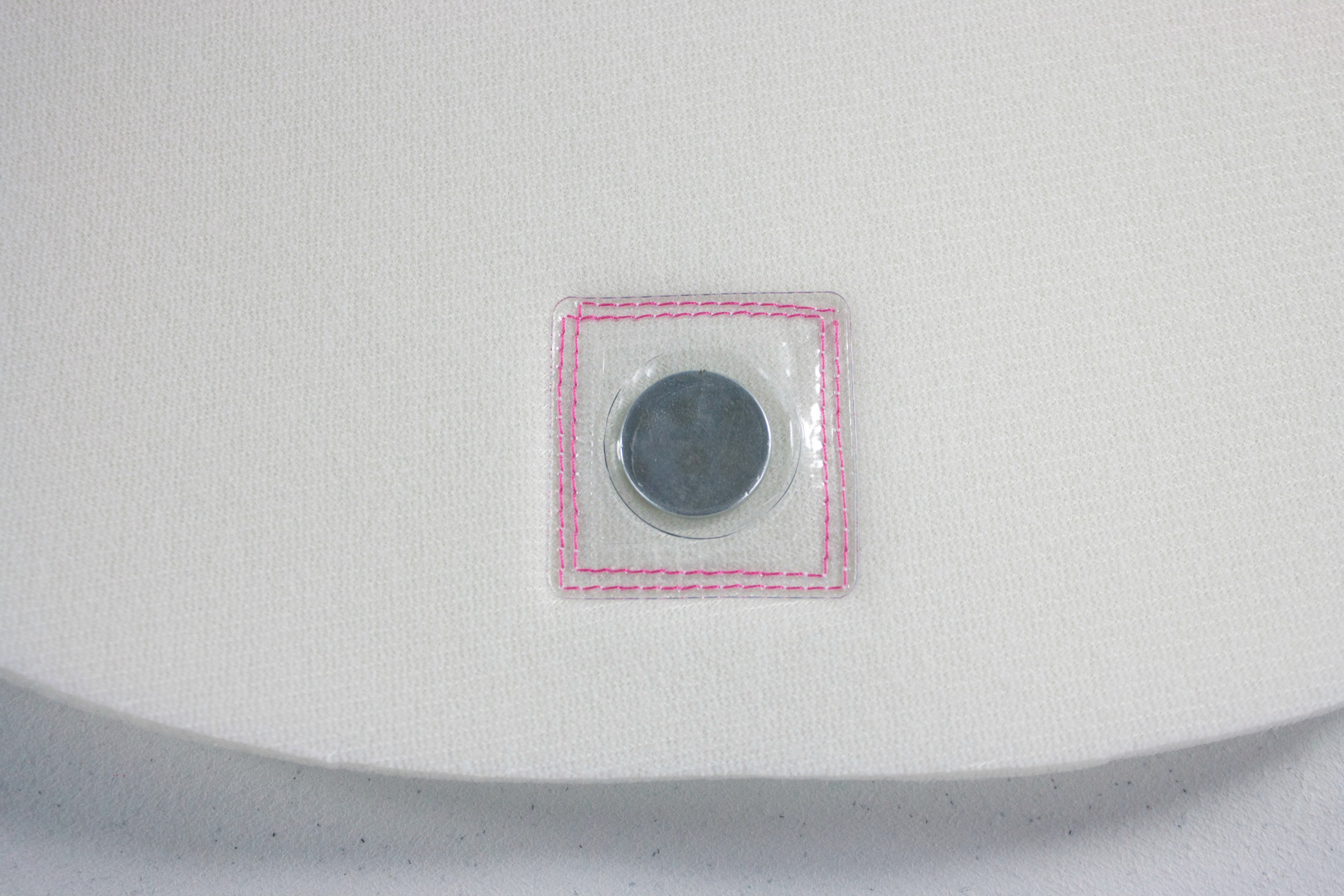 Stitching the invisible magnetic snap in place.