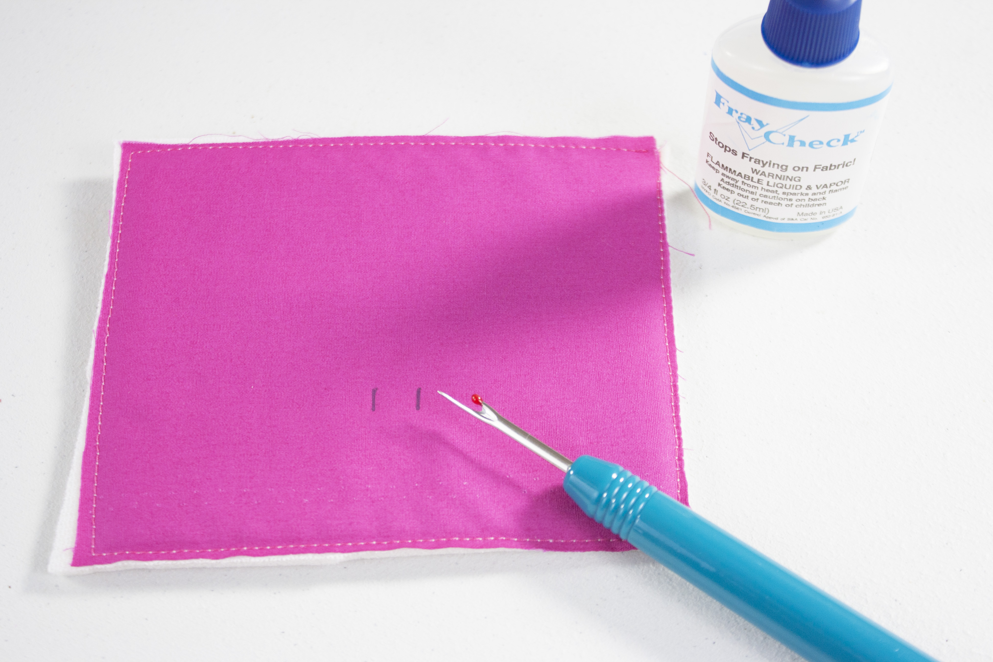 Using seam ripper to make small slits in the fabric/interfacing.