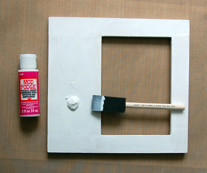 Apply Mod Podge to front of frame and adhere paper