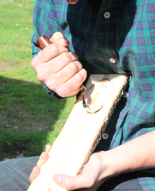 Using a hook knife to carve out the bowl of the spoon method two