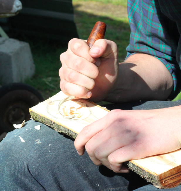 Using a hook knife to carve out the bowl of the spoon method three