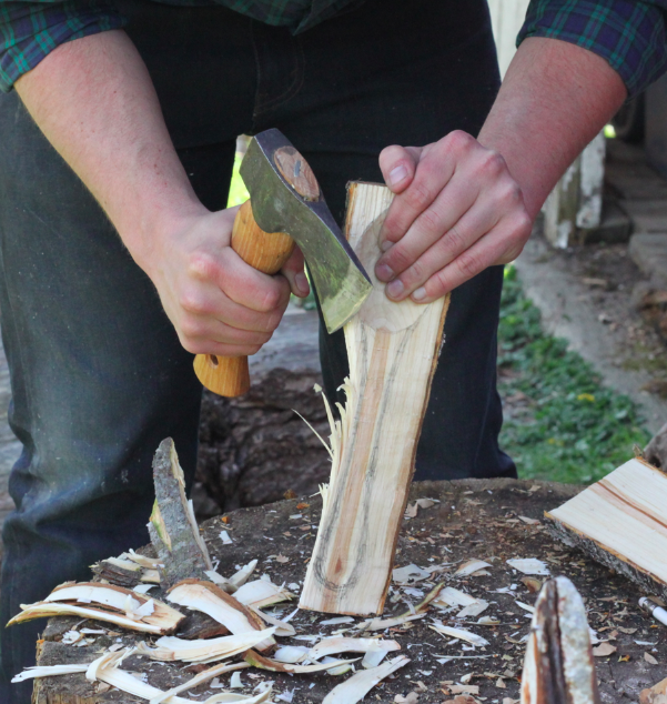 rough shaping one side of the workpiece with a hatchet