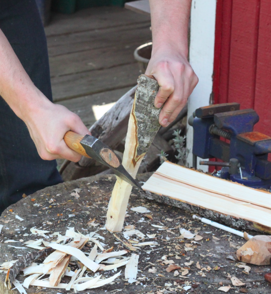 rough shaping the sides of the spoon with a hatchet