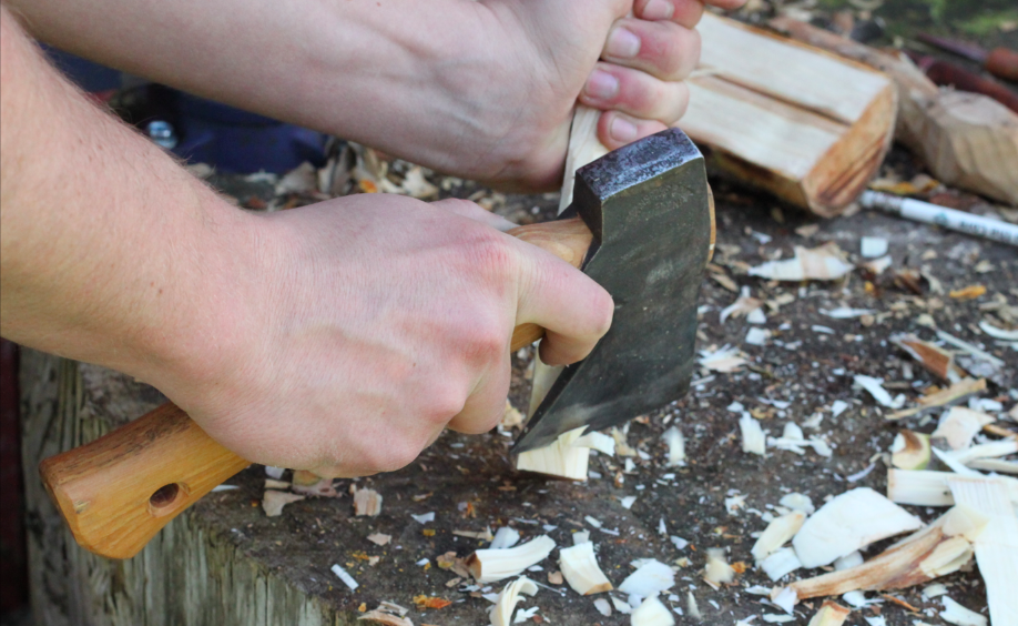 finishing rough shaping the spoon with a hatchet