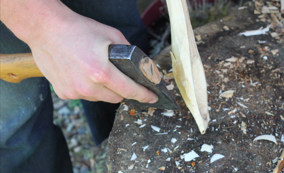 rough shaping the bowl of the spoon with a hatchet