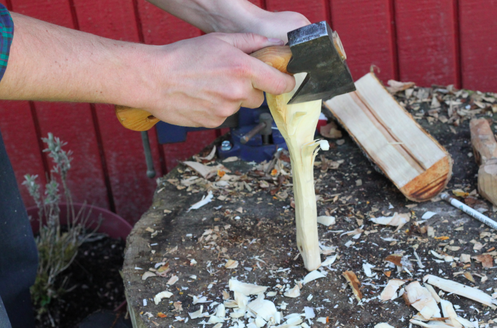 rough shaping the back of the spoon with a hatchet