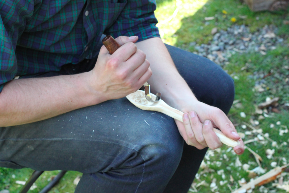 Refining the shape of the spoon bowl using a hook knife