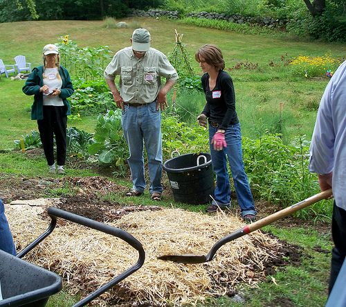 A group builds lasagna garden layers
