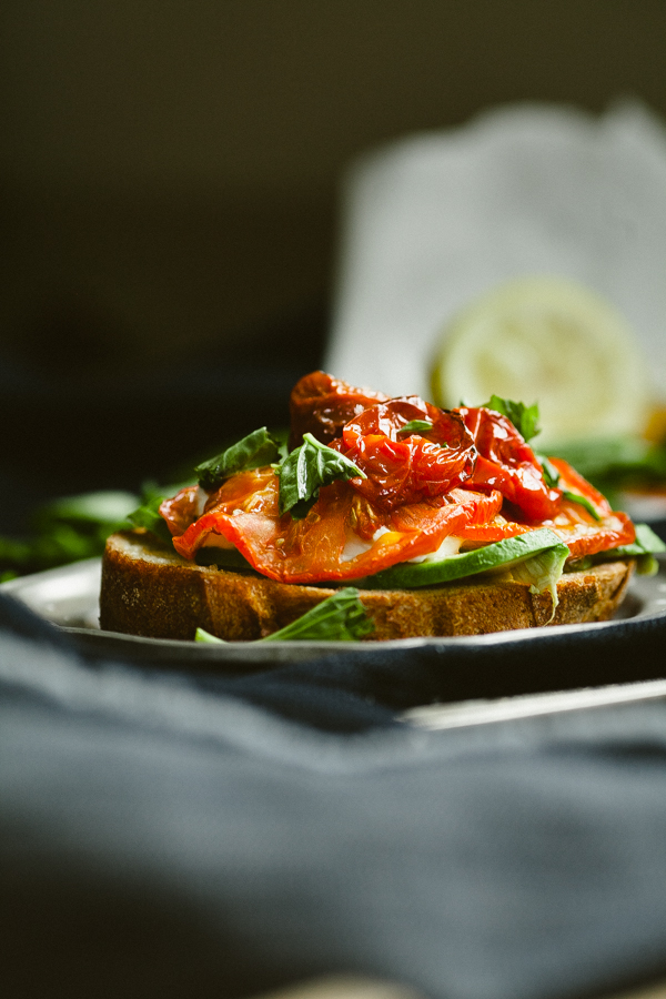 open faced tomato and greens sandwich