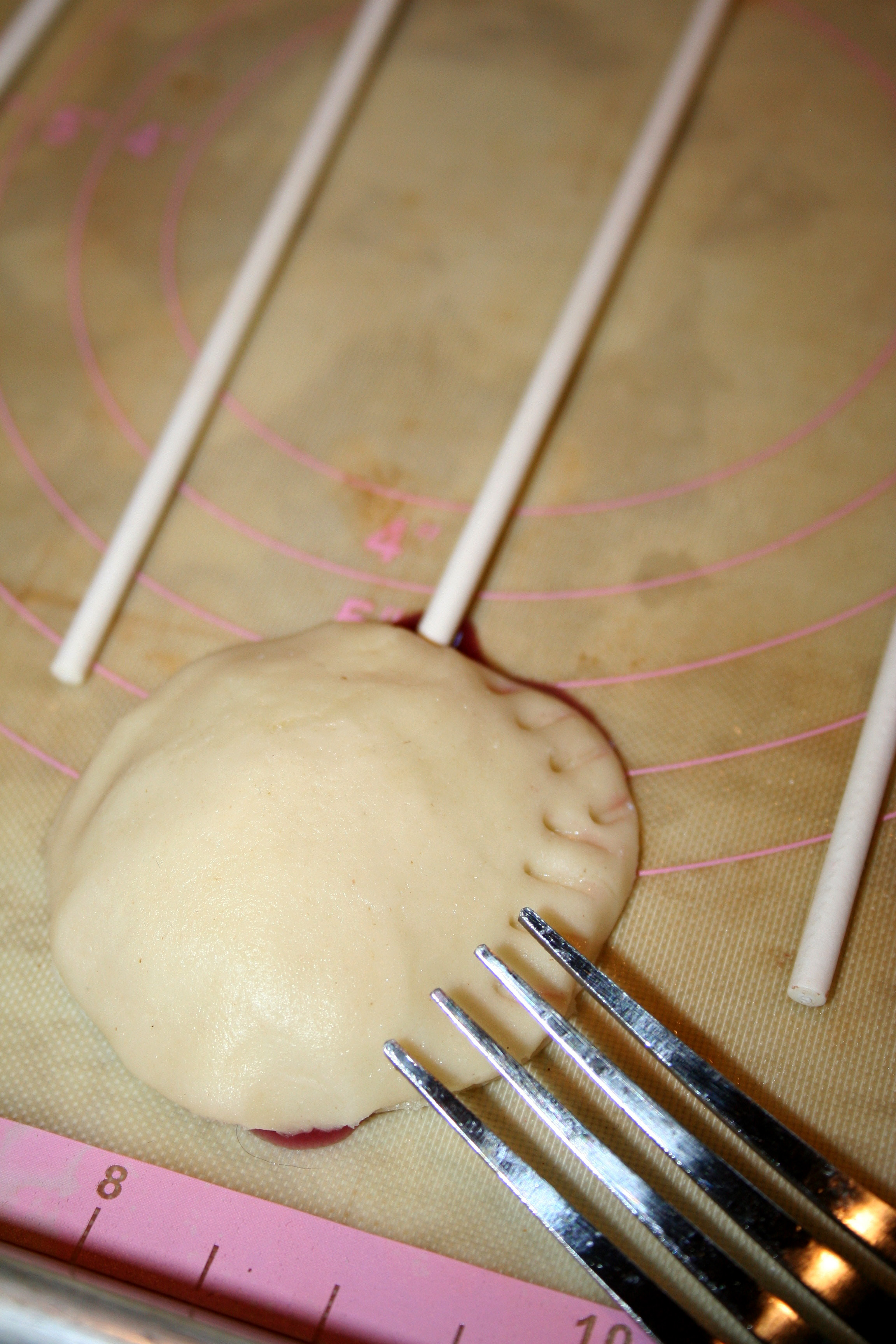 Pressing pie pops with tines of fork