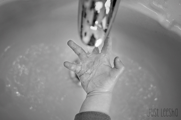 hand under running faucet