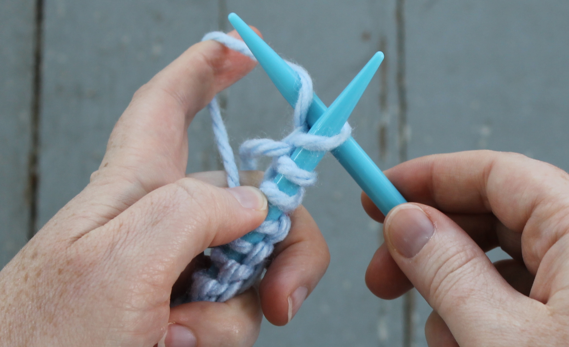 Wrapping yarn to make a knit stitch